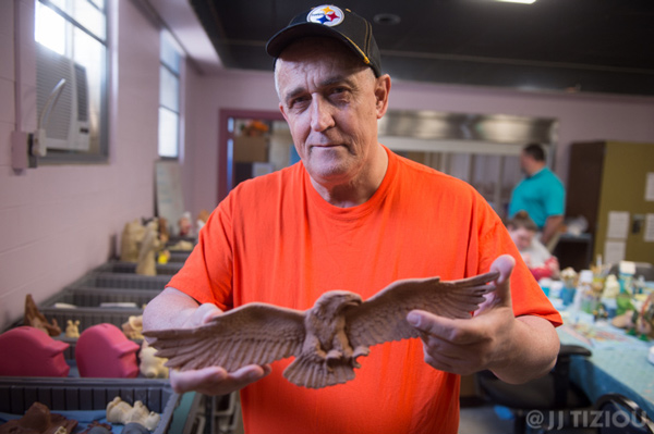 Jim C. holds a model replica of an eagle