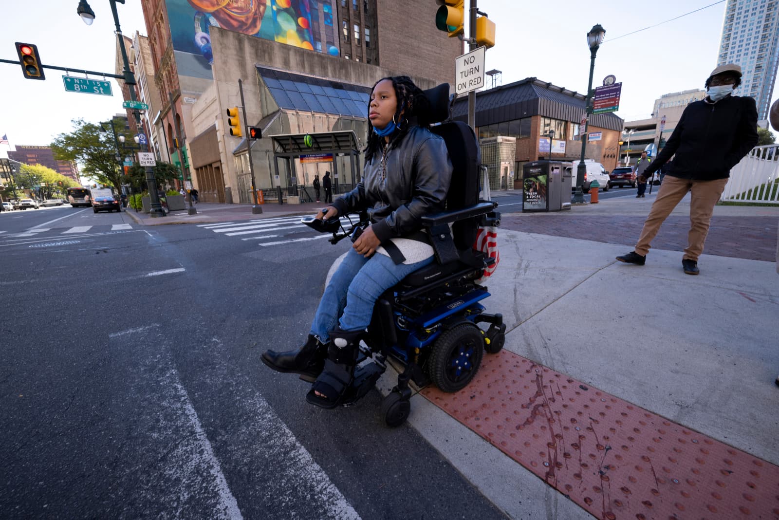 Domonique waits for light to change at city intersection