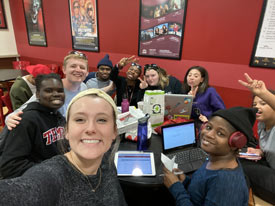 LCS students and coaches at table in Temple's student center