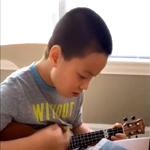 Ming Ting's son playing a ukelele