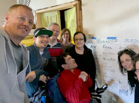 Robert with a close group of people, indoors