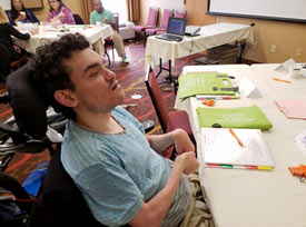 Robert sitting at a table with papers and pencils