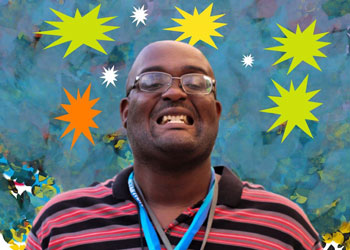 William smiles. The blue background of this picture includes colorful painted stars