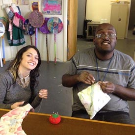 William and a woman sewing at a table