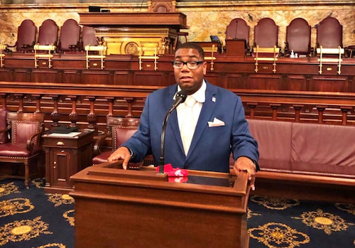 Shawn Aleong at a podium in Pennsylvania Capitol building