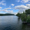 View of the Delaware River between New Hope Pennsylvania and Lambertville New Jersey, with homes on both shores and a partially cloudy sky
