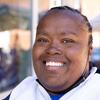 Close-up portrait of LaToya, who smiles, eyes sparkling