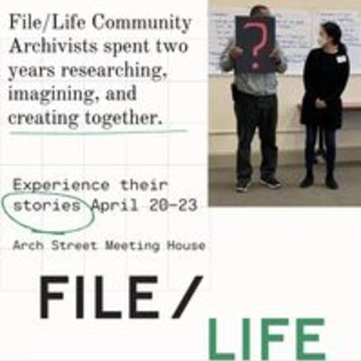 2 people in front of classroom, 1 holding handmade sign that has a large question mark. Text: File Life community archivists spent two years researching, imagining, and creating together.